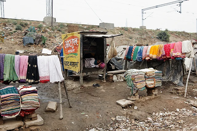 An Indian slum alongside the road and railway track in Varanasi, India. (Photo: iStock)