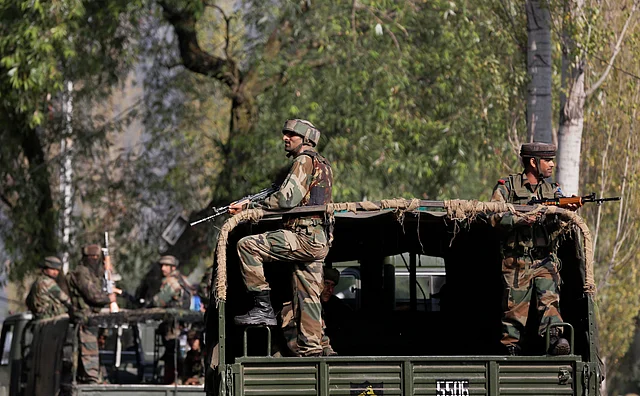Indian soldiers guard outside the army base which was attacked on Sunday by suspected militants at Uri, Kashmir. (Photo: AP)