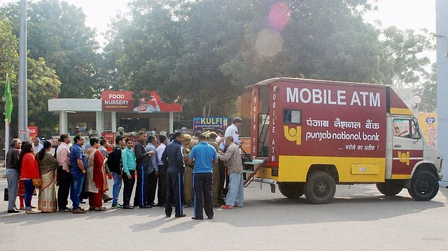 People collecting money from a mobile ATM at Pragati Maidan in New Delhi, 14 November 2016. (Photo: PTI)