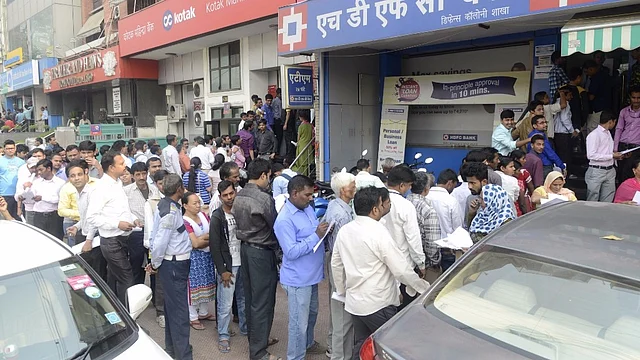 People wait outside banks to exchange currency notes in New Delhi on 11 November 2016. (Photo: IANS)