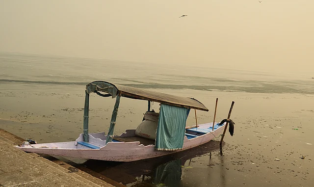 A Shikara waits for tourists as Dal lake freezes. Kashmir has lost its tourist season to unrest post a young militant leader Burhan Wani’s encounter in July 2016.