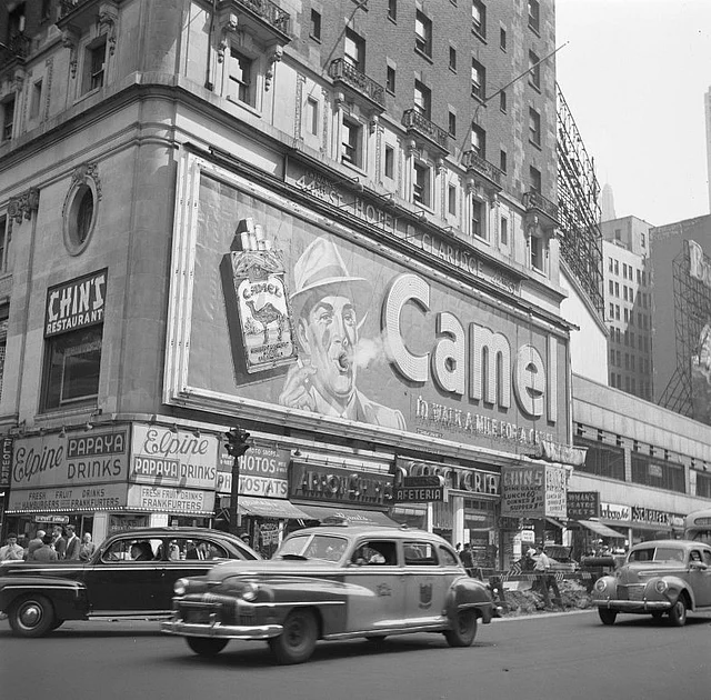 A Camel billboard in New York’s Times Square in 1948. (Photo Courtesy: <a href="https://en.wikipedia.org/wiki/Camel_(cigarette)#/media/File:Rokend_Camel-reclamebord_Smoking_billboard.jpg">Wikipedia</a>)