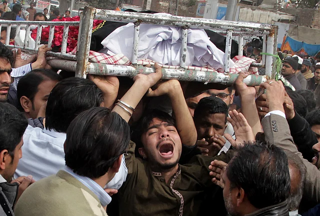 People mourn the death of a family member who was killed in the suicide blast. (Photo: AP)