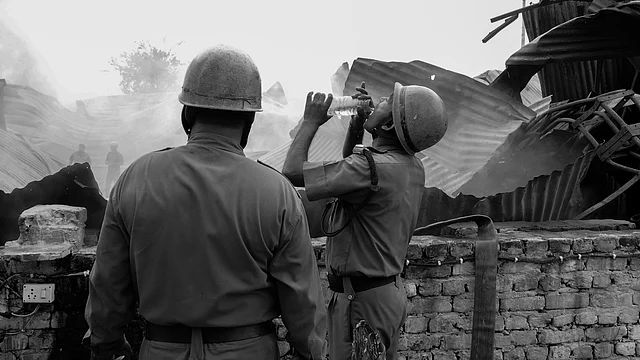A fireman takes a sip of water while fighting fire. (Photo courtesy: Sameer Khan) 