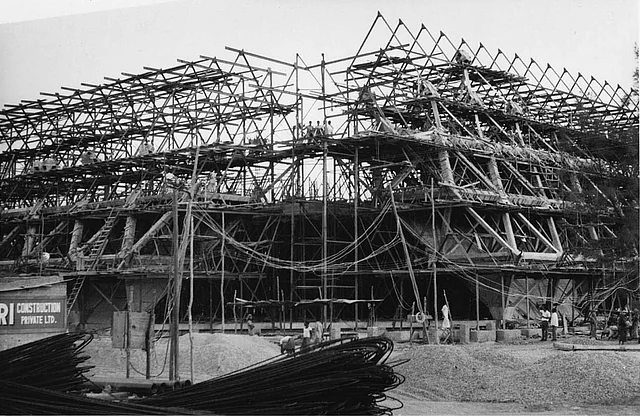 Halls of Nations and Industries under construction. (Photo: Copyright Mahendra Raj Archive/(HELLANS Industrial & Pictorial Photographers, New Delhi) via <a href="https://architexturez.net/doc/az-cf-123722">Architexturez.net</a>)