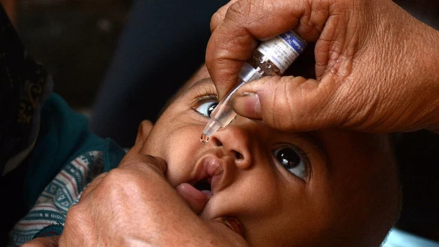 A child being administered polio drops.