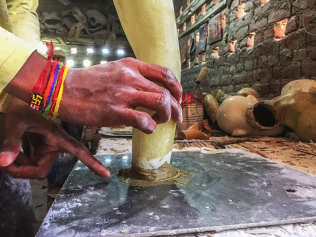 A worker fixing a mannequin hand at the factory. (Photo: Erum Gour/<b>The Quint</b>)
