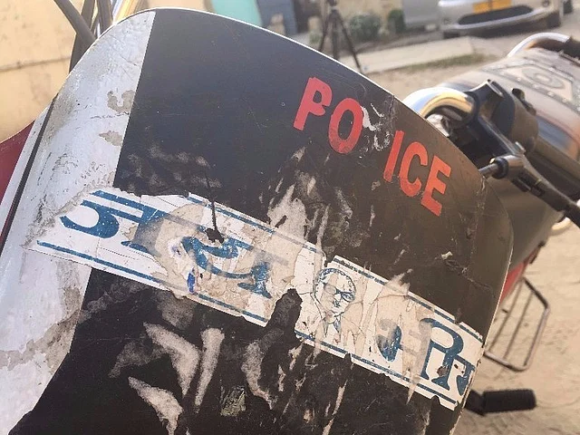 Interestingly enough, Chandrashekhar’s bike has a police sticker plastered on it along with one saluting Ambedkar. (Photo: Meghnad Bose/<b>The Quint</b>)