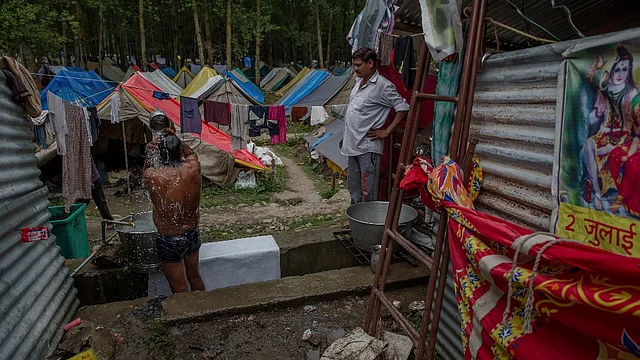 A pilgrim bathes at a base camp after returning from the Amarnath Shrine, in Pahalgam, Kashmir, 11 July, 2017.