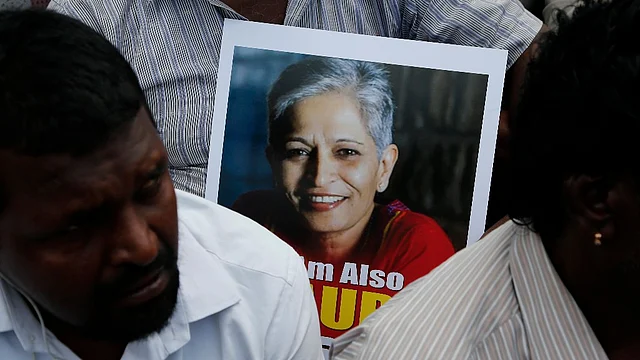 A participant holds a placard with a photograph of Indian journalist Gauri Lankesh at a protest demonstration against her killing in Bengaluru.