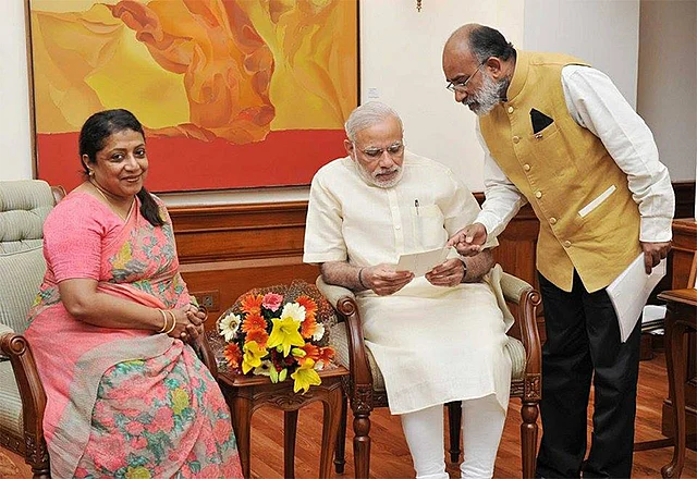 Alphons Kannanthanam with Prime Minister Modi and his wife.