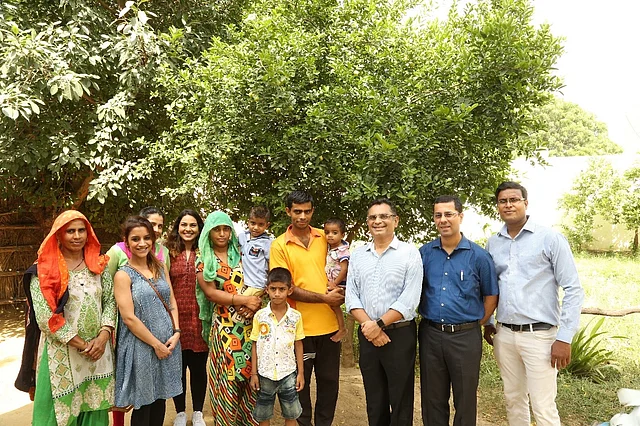 Anjali and her family with the Genesis Foundation team.