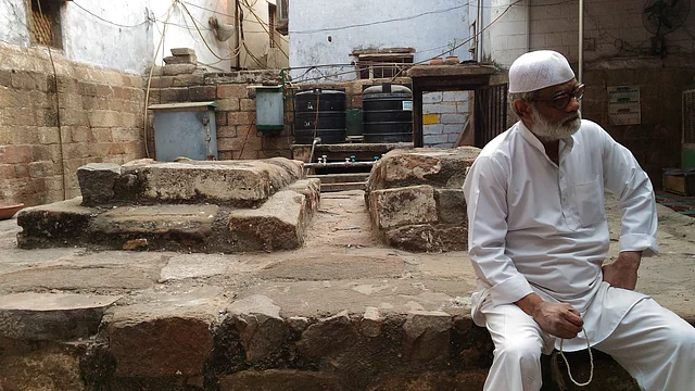 A man resting by the grave of Raziya Sultan.