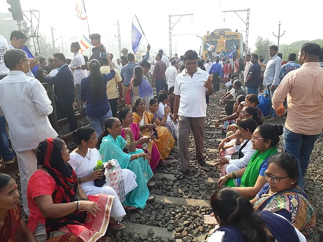 Protesters occupy the railway tracks at Nala Sopara Station in Mumbai