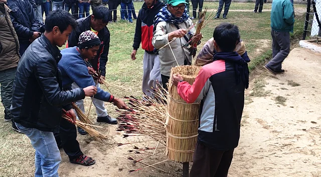 The arrows being taken out from the target to be counted. 