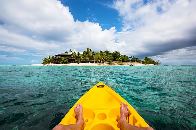 Kayaking by a tropical island in Fiji. 