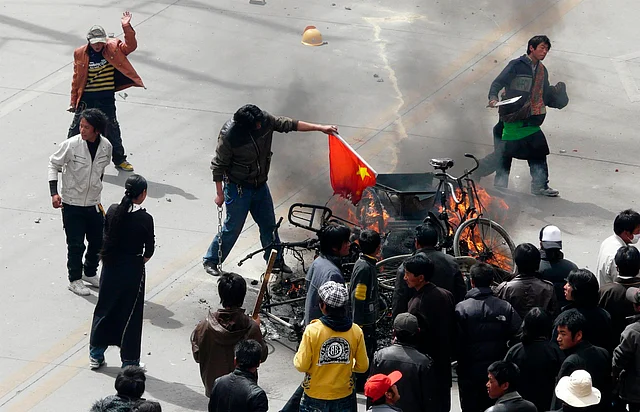 Tibetans burning a Chinese flag in March, 2008.