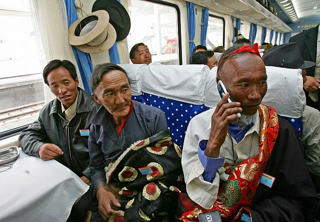 Passengers sit on board the first train at Lhasa railway station as it heads for Lanzhou in Gansu province 1 July 2006.