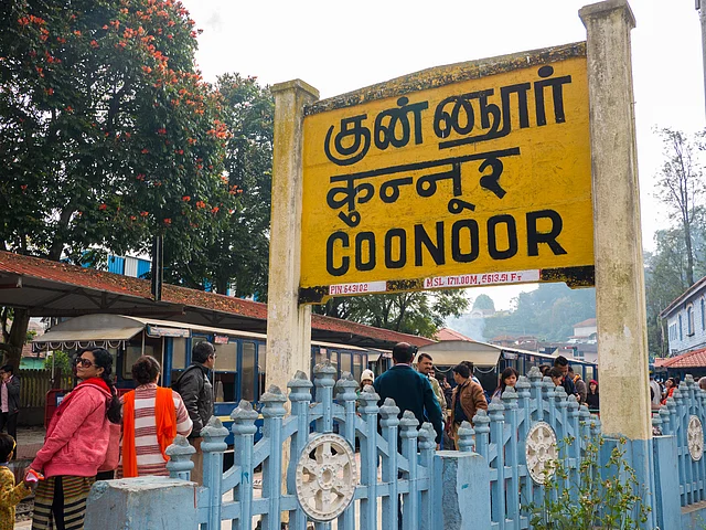 Nilgiri mountain railway. Blue train. People waiting for the train. The train station of Coonoor.
