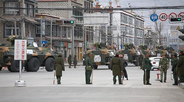 A convoy of armoured personnel carriers (APC) travel through the streets of Lhasa, Tibet March 15, 2008. 