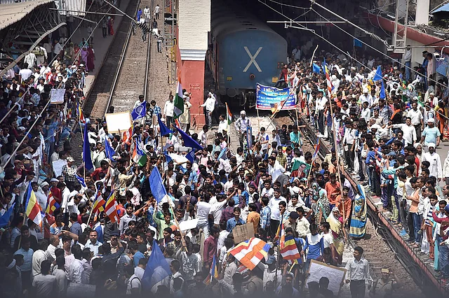 Hundreds of protesters block the railway track during Bharat Bandh call by Dalit organisations in Aligarh on 2 April.