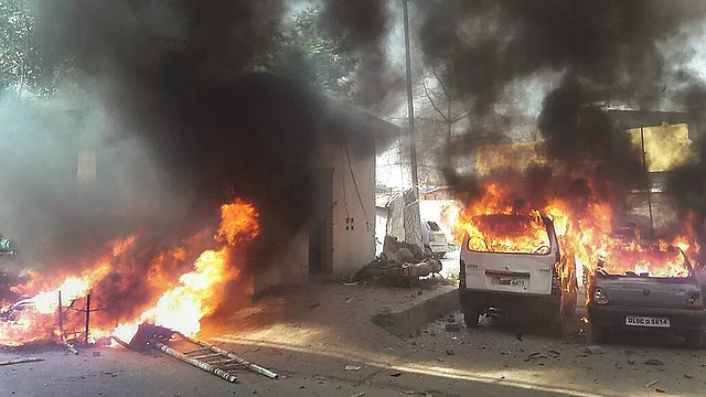 Vehicles set on fire by a group of protesters in Meerut on 2 April 2018.