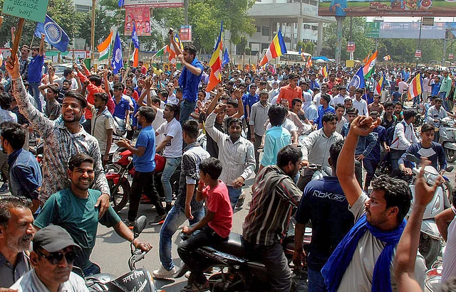 Hundreds of protesters block the road during Bharat Bandh in Ghaziabad on 2 April.
