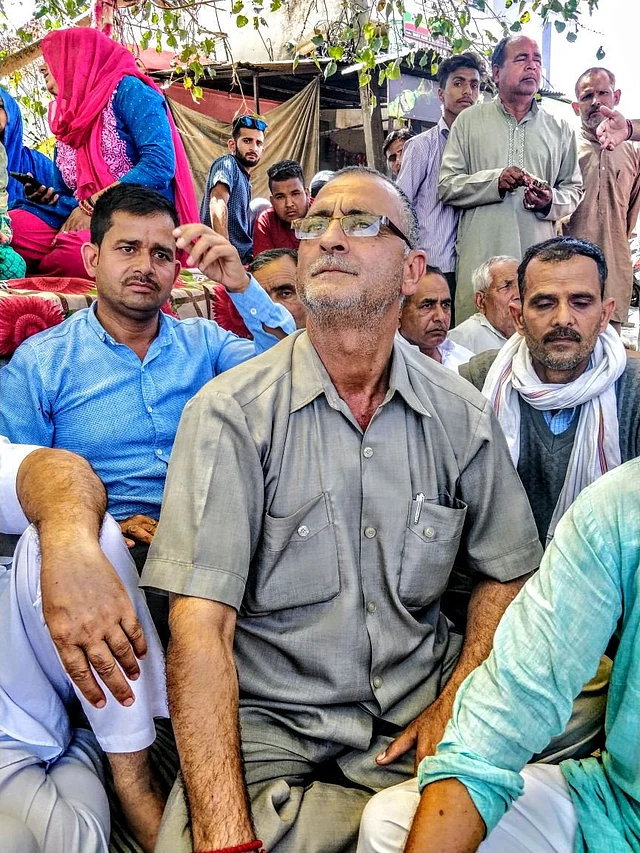 Bagmal Khajuria listens as Kant Kumar, the vice president of Hindu Ekta Manch, speaks.