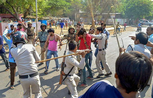 Police personnel lathi charge protesters in Gwalior on 2 April.