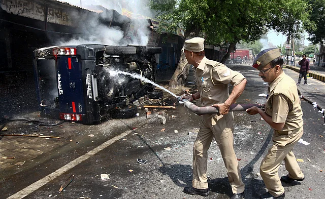 A police vehicle that was set ablaze in Meerut, UP.