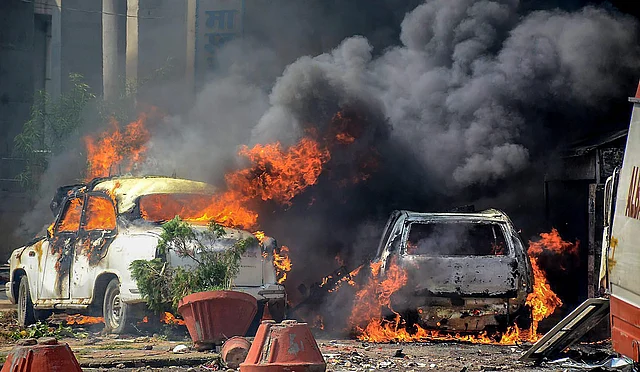 Smoke billows out of burning cars in Muzzaffarnagar on 2 April 2018.