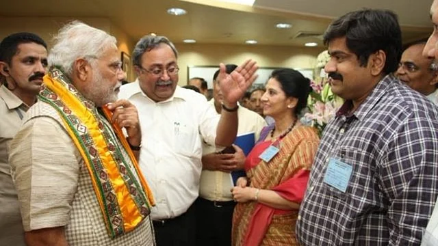 Amit Bhatnagar (right) with PM Narendra Modi (left) and BJP leader Saurabh Patel (centre). 