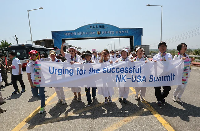 Activists cross the Unification Bridge, which leads to Panmunjom in the Demilitarized Zone, during the 2018 DMZ Women Peace Walk in Paju, South Korea, Saturday, 26 May, 2018. 