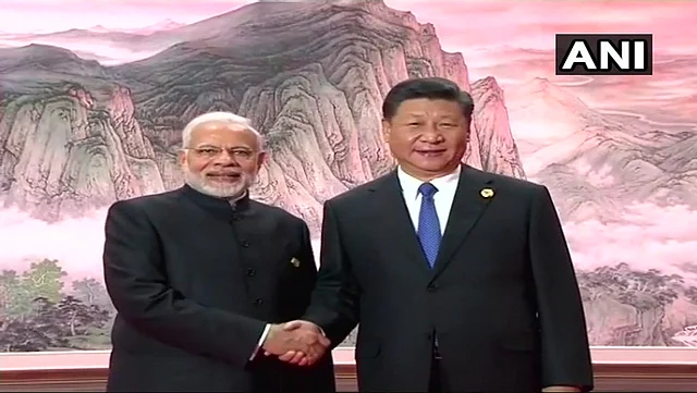 PM Narendra Modi met Chinese President Xi Jinping and shared a handshake.