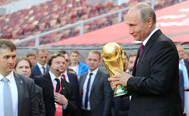 A photo of Vladimir Putin holding the World Cup trophy at the Luzhniki Stadium in Moscow released by the Kremlin.