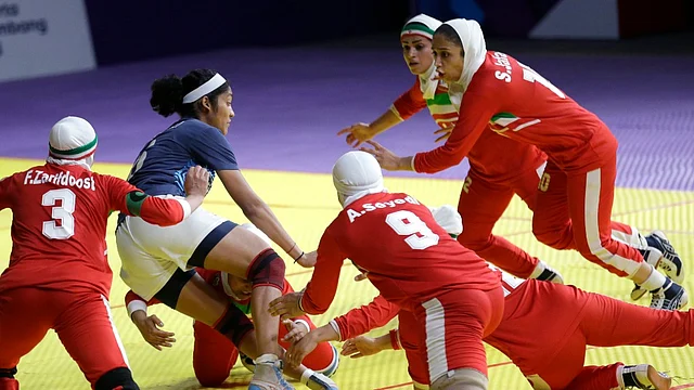 India’s Sonali Shingate gets caught between Iranian defenders.