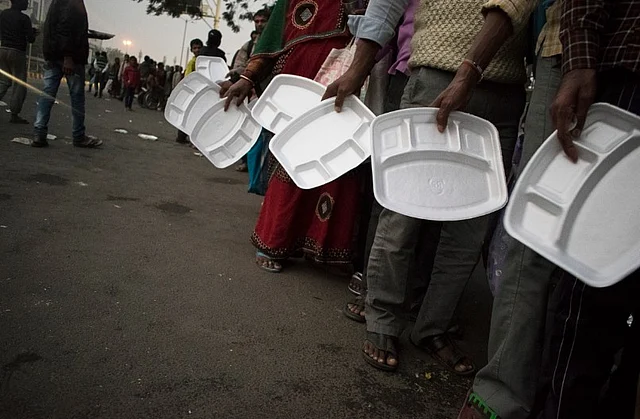 People waiting for food provided by an NGO outside AIIMS, Delhi