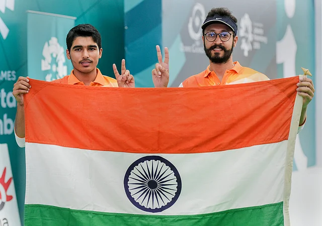Indian shooters Gold medalist Saurabh Chaudhary (L) and Bronze medalist Abhishek Verma (R) after the 10m air pistol men’s shooting at the 18th Asian Games Jakarta Palembang 2018.