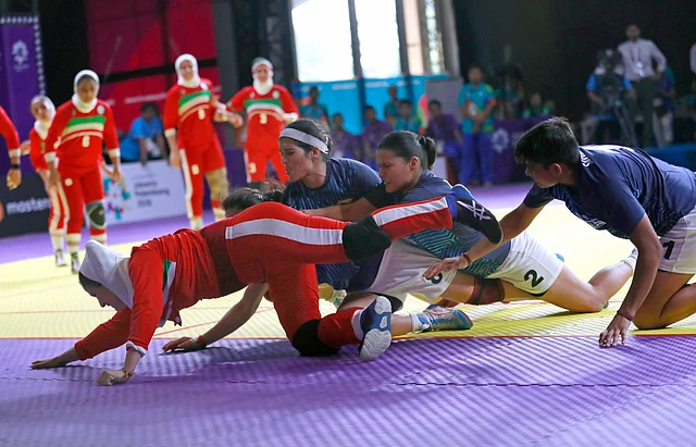 Iran’s Saeideh Jafarikoochi, in red, tries to stretch to the line.