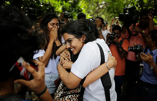 Supporters congratulate each other after the apex court’s verdict in New Delhi.