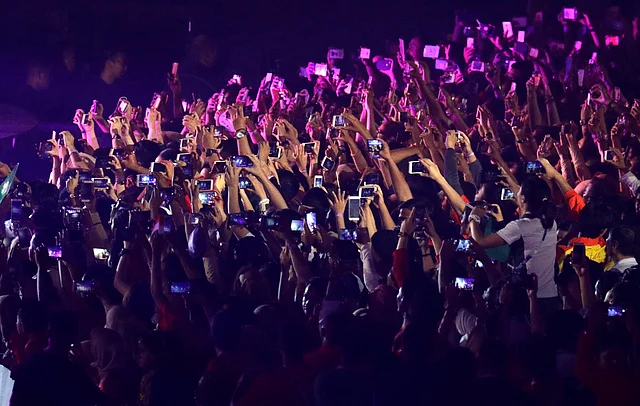 Spectators film the closing ceremony for the 18th Asian Games on their mobile phones in Jakarta, Indonesia on Sunday.