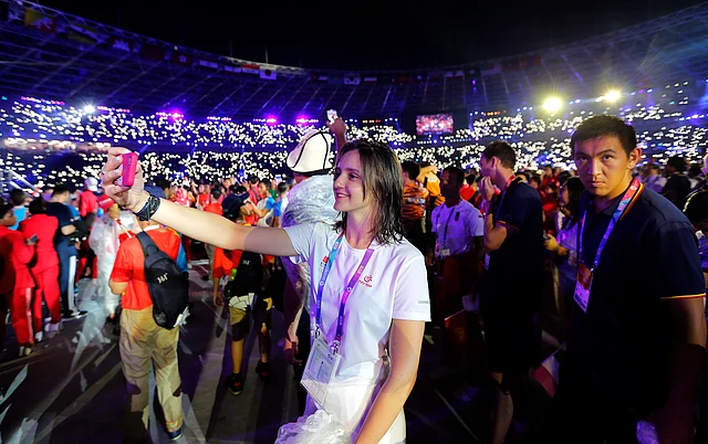 Athletes take selfies during the closing ceremony for the 18th Asian Games in Jakarta, Indonesia.