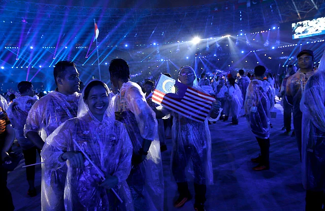 Malaysian athletes participate in the closing ceremony for the 18th Asian Games in Jakarta, Indonesia