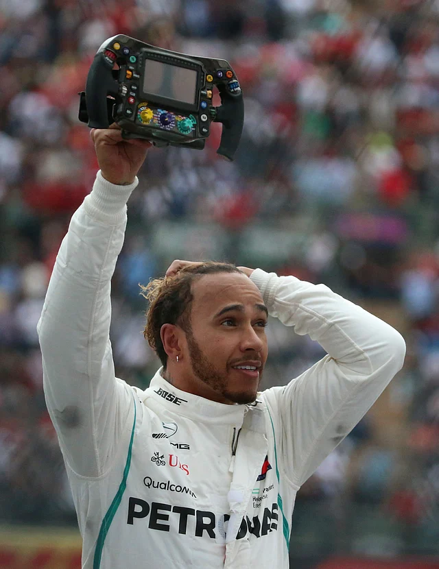 Mercedes driver Lewis Hamilton, of Britain, holds his steering wheel after becoming Formula One Champion at the Mexico Grand Prix auto race at the Hermanos Rodriguez racetrack in Mexico City, Sunday, Oct. 28, 2018.