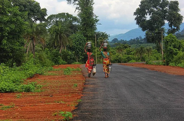 Two women walk to their homes. 