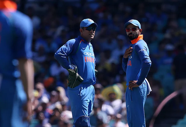 Virat Kohli consults former skipper MS Dhoni during an ODI against Australia.