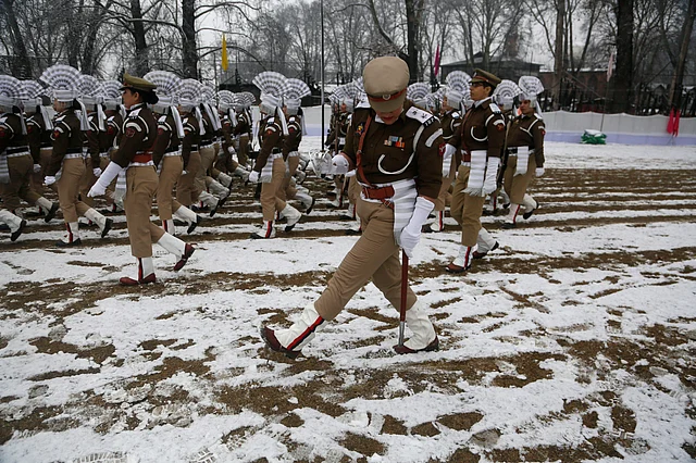 A Jammu Kashmir policewoman navigates her way through snow as she marches during a rehearsal for Republic Day in Srinagar, Kashmir on 24 January 2019. 