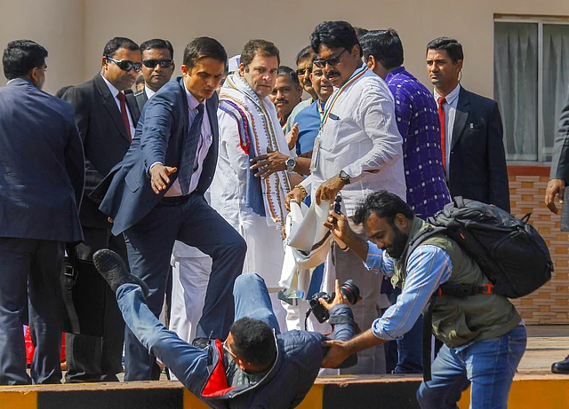 A photographer falls down while covering Congress President Rahul Gandhis arrival at Biju Patnaik International Airport in Bhubaneswar, Odisha, on 25 January 2019.