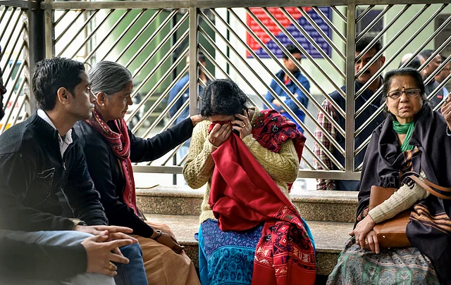 Family members of victims who died in Hotel Arpit Palace fire accident mourn outside the mortuary at Ram Manohar Lohia (RML) Hospital in New Delhi. 