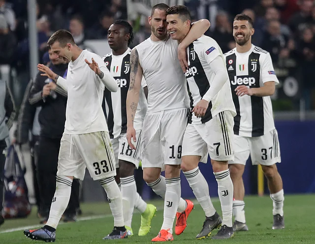 Juventus’ Leonardo Bonucci, centre left and Cristiano Ronaldo hug at the end of the Champions League round of 16, 2nd leg, soccer match.